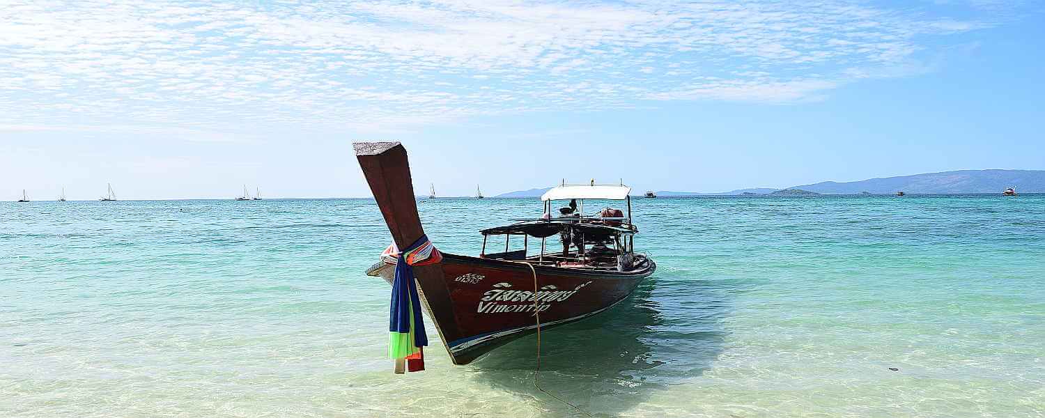 Thai boat at Sunrise Beach Koh Lipe slider image