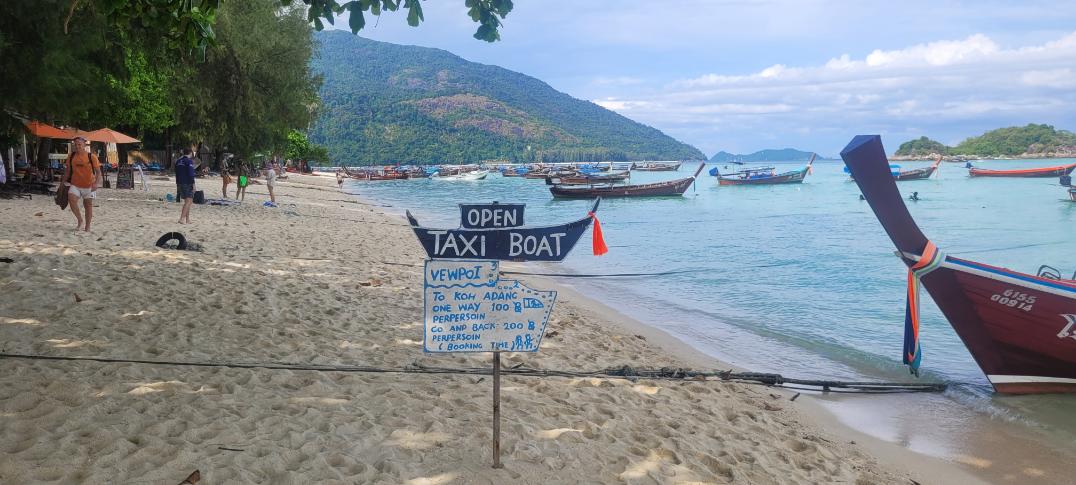 Taxi boat sign with prices from Koh Lipe to Koh Adang. One way 100 baht